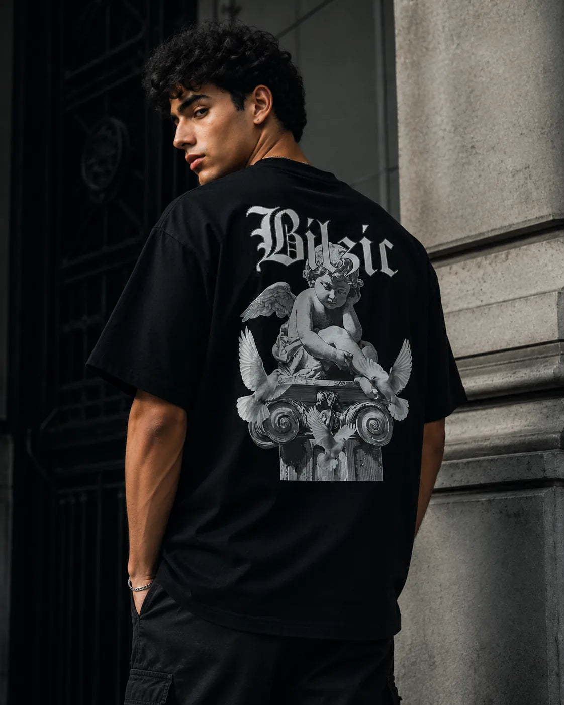 Model wearing the Divine Silence tee, cherub print across the back